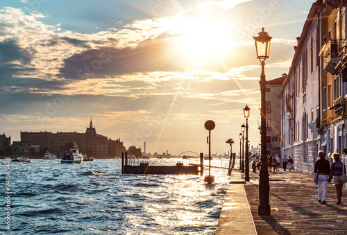 Venezia Venice - Promenade of Zattere with a Couple walking in Backlit photo