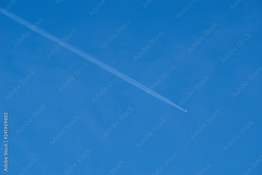 Plane flying on a blue sky, condensation line. Plane flying on a blue sky, condensation line.