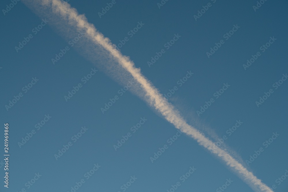 Plane flying on a blue sky, condensation line. Plane flying on a blue sky, condensation line.