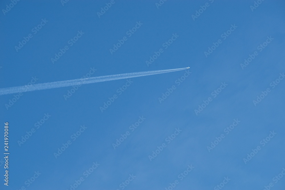 Plane flying on a blue sky, condensation line. Plane flying on a blue sky, condensation line.