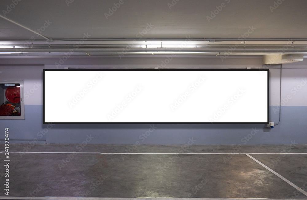indoor car parking and empty white billboard .Blank space for text and images. indoor car parking and empty white billboard .Blank space for text and images.