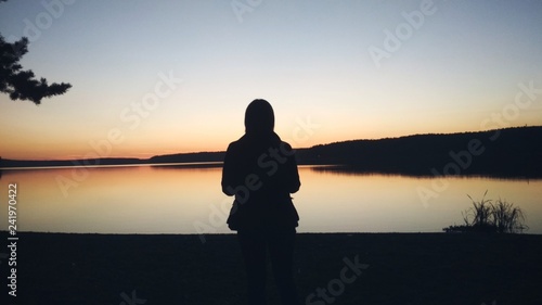 silhouette of young woman on background of sunset
