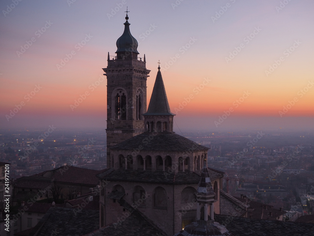 Bergamo, Italy. The old town. Aerial view of the Basilica of Santa Maria Maggiore during the sunset. In the background the Po plain
