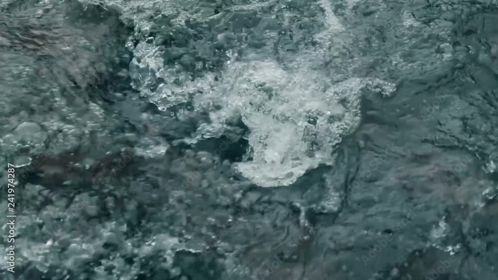 Winter waterfall river close up in slow motion. Crystal water in the mountains. Winter waterfall river close up in slow motion. Crystal water in the mountains.