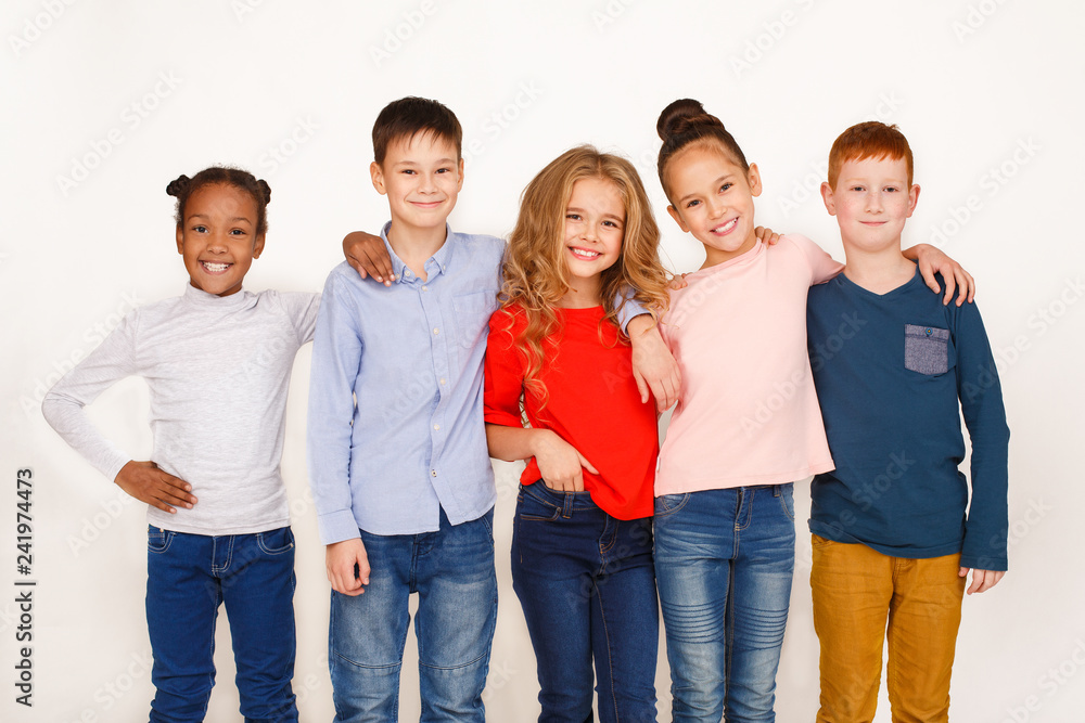 Kids hugging and looking at camera against white background Kids hugging and looking at camera against white background