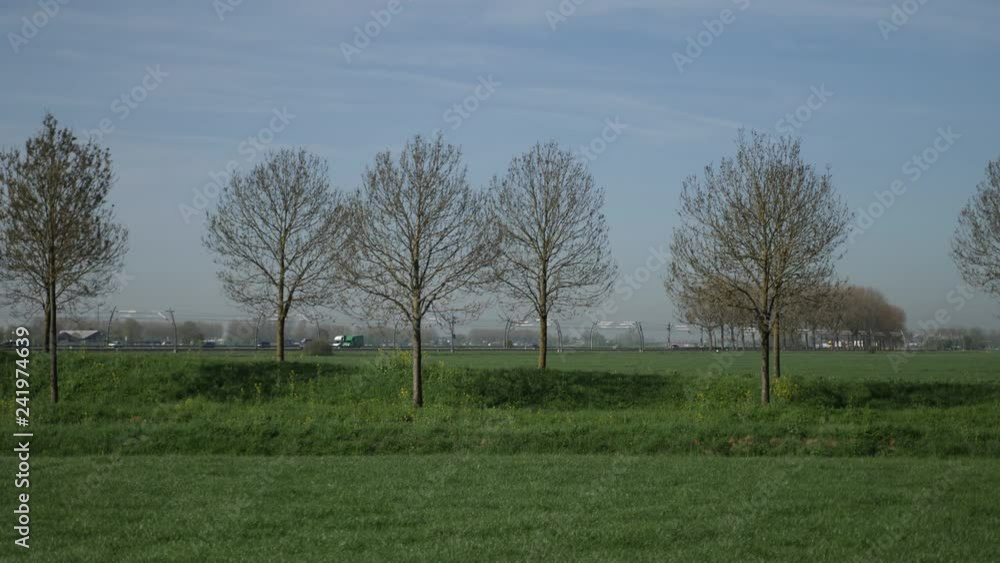 Wide angle view of Betuweroute train route in Netherlands Betuwelijn 4k train crossing from left to the right Wide angle view of Betuweroute train route in Netherlands Betuwelijn 4k train crossing from left to the right