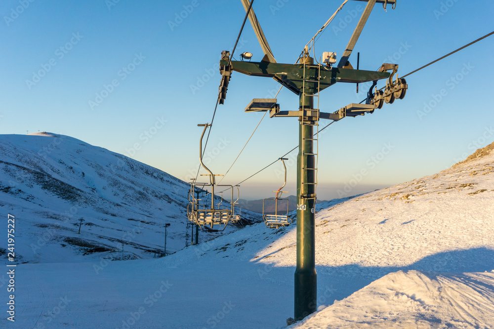 Ski lifts going over the mountain near a ski resort 
