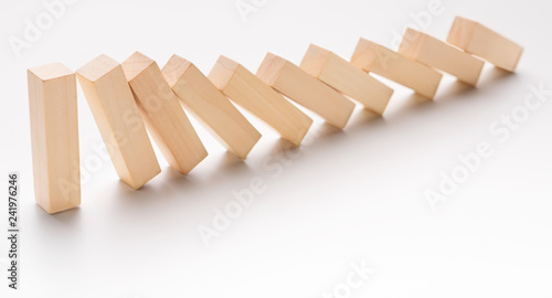 One wooden block stop other ones falling like dominoes