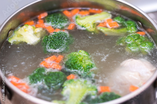 boiling soup in the pan. broccoli, carrots, potatoes, chicken