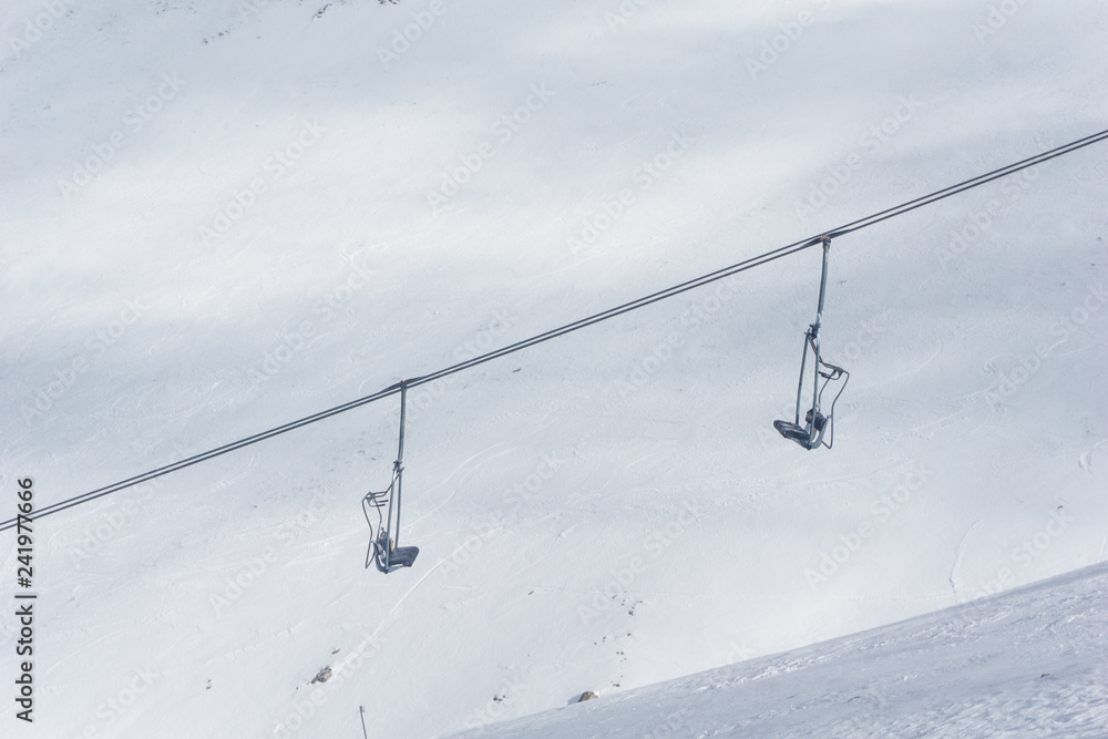 Ski lifts going over the mountain near a ski resort Ski lifts going over the mountain near a ski resort