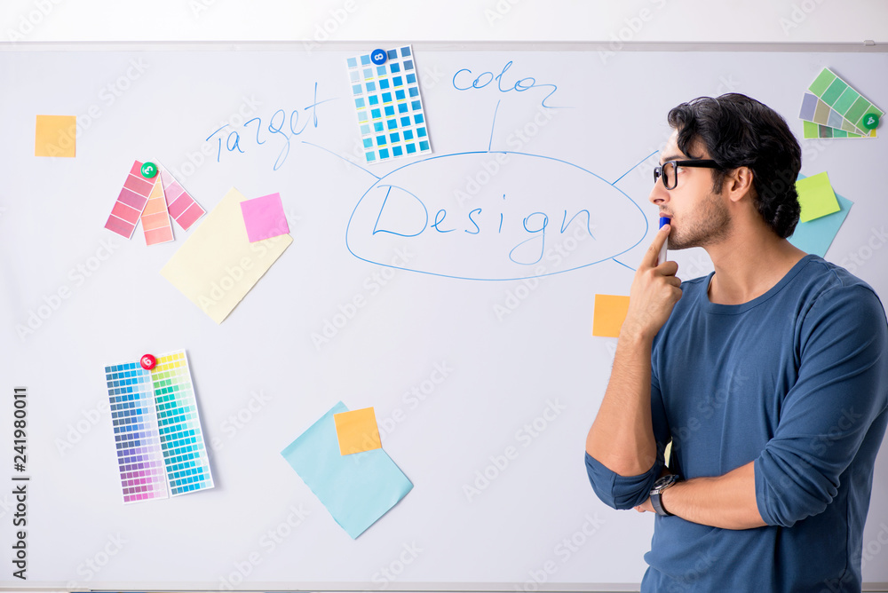 Young handsome designer working at the project Young handsome designer working at the project