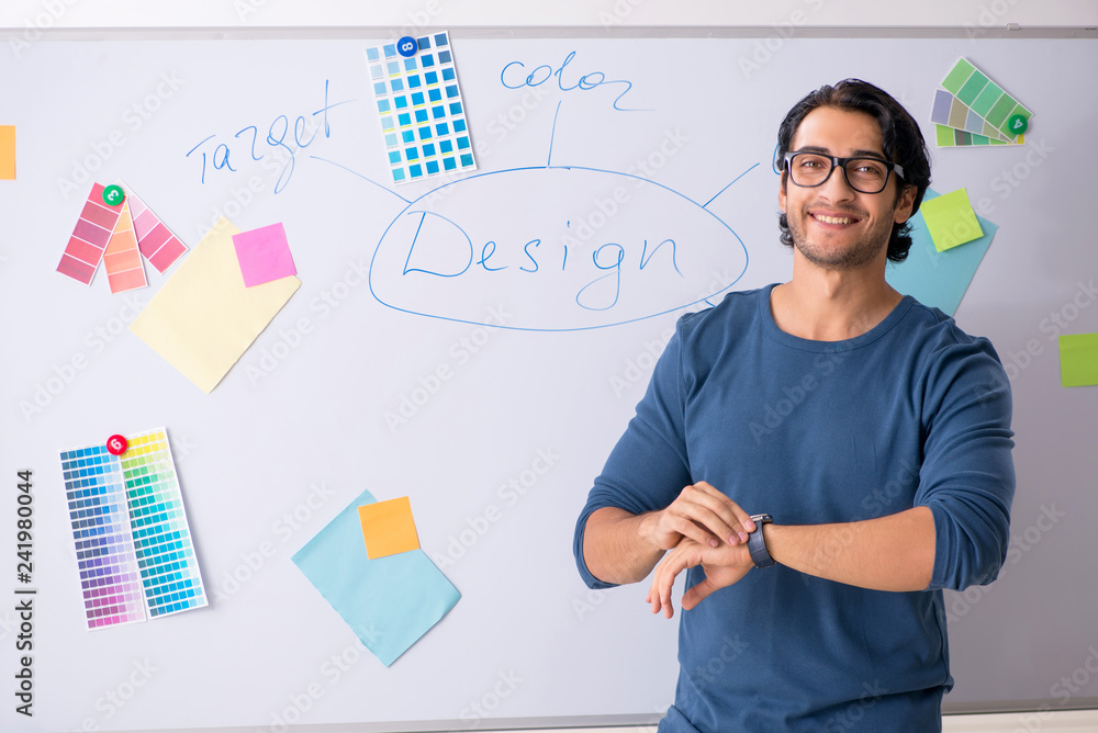 Young handsome designer working at the project Young handsome designer working at the project