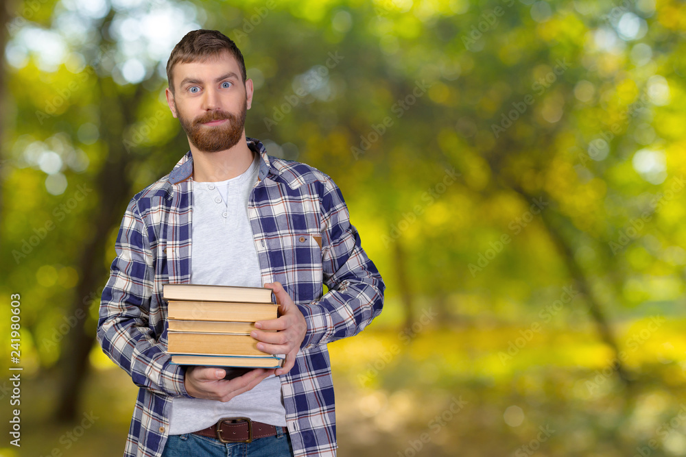 Young Man Holding Stack Of Books Young Man Holding Stack Of Books