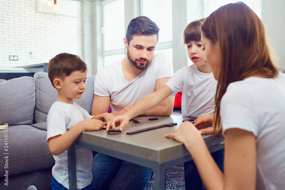 Happy family playing board games at home. Happy family playing board games at home.