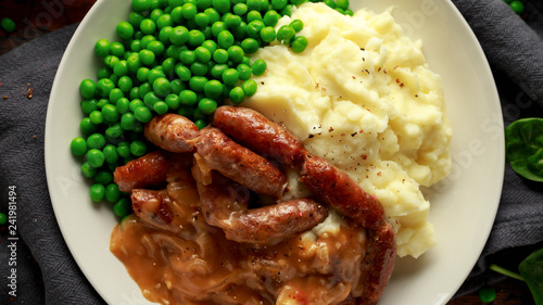Mashed potatoes and sausages, bangers with onions gravy, green peas