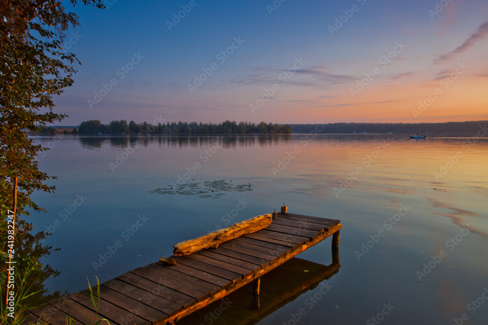 Dawn light. Orange - a blue lake landscape.