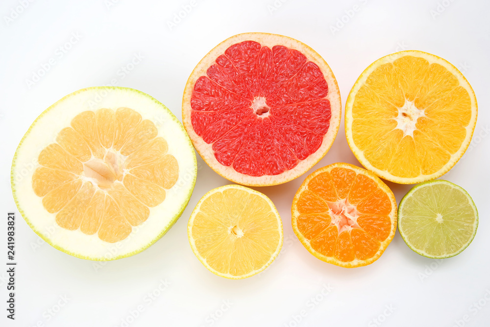 cut pieces of different citrus fruits on white background cut pieces of different citrus fruits on white background