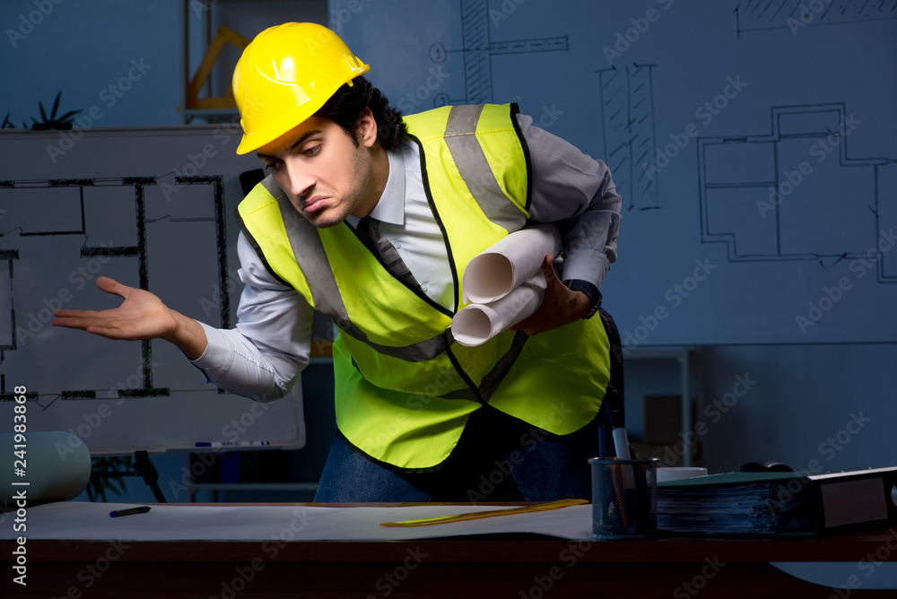 Young construction architect working on project at night Young construction architect working on project at night