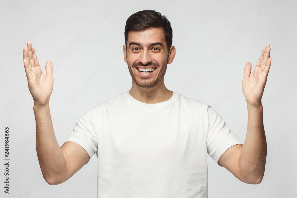 European male showing big size gesture with arms and hands emphasizing great amount of something European male showing big size gesture with arms and hands emphasizing great amount of something