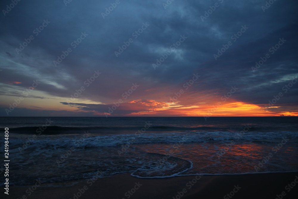 Obraz premium Wave art in the water's edge after sunset in the twiglight in summertime