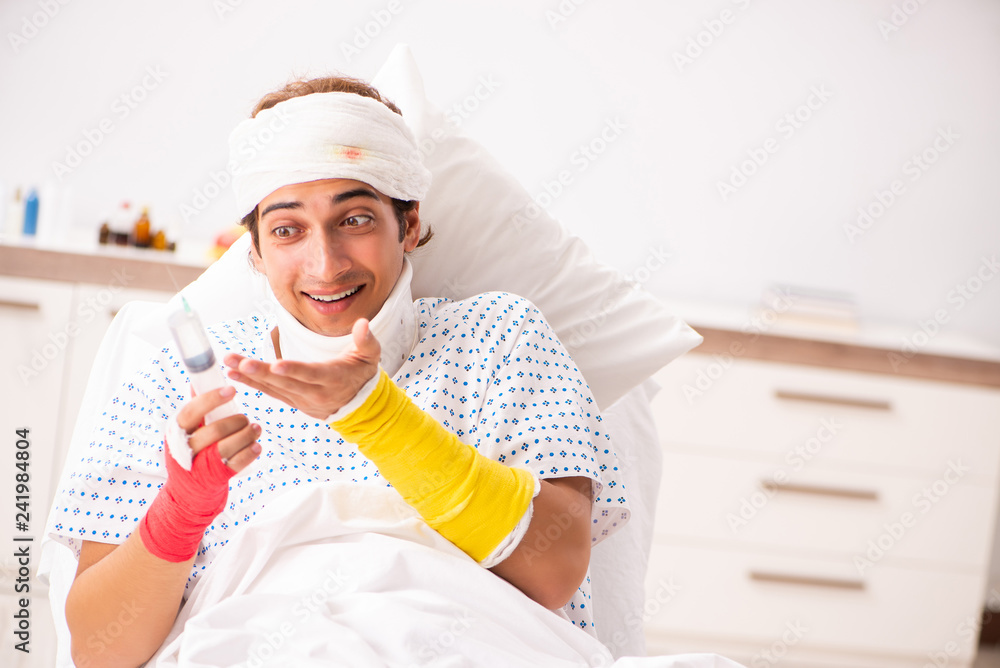 Young doctor examining injured patient Young doctor examining injured patient