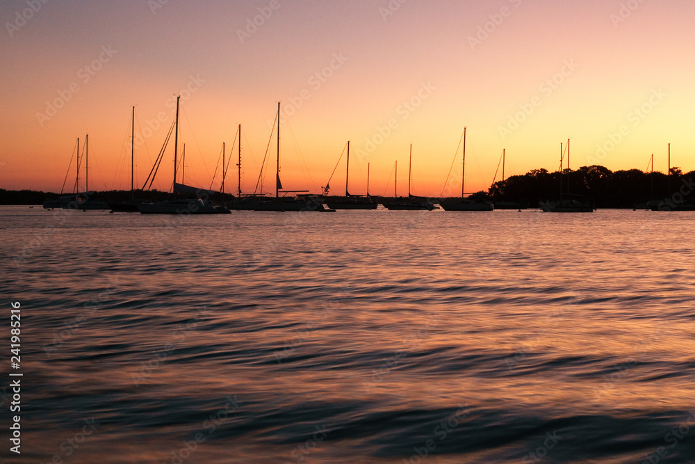 Florida peaceful sunset with sailboats in harbor