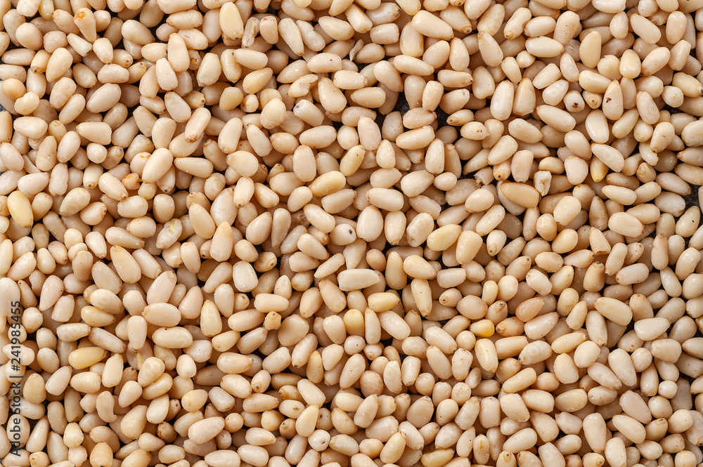 Background made of peeled pine nuts. Background made of peeled pine nuts.