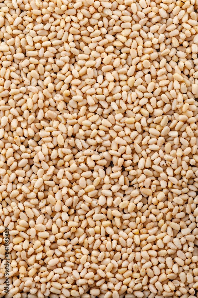 Background made of peeled pine nuts. Vertical frame. Background made of peeled pine nuts. Vertical frame.