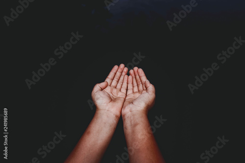 praying hands on black background