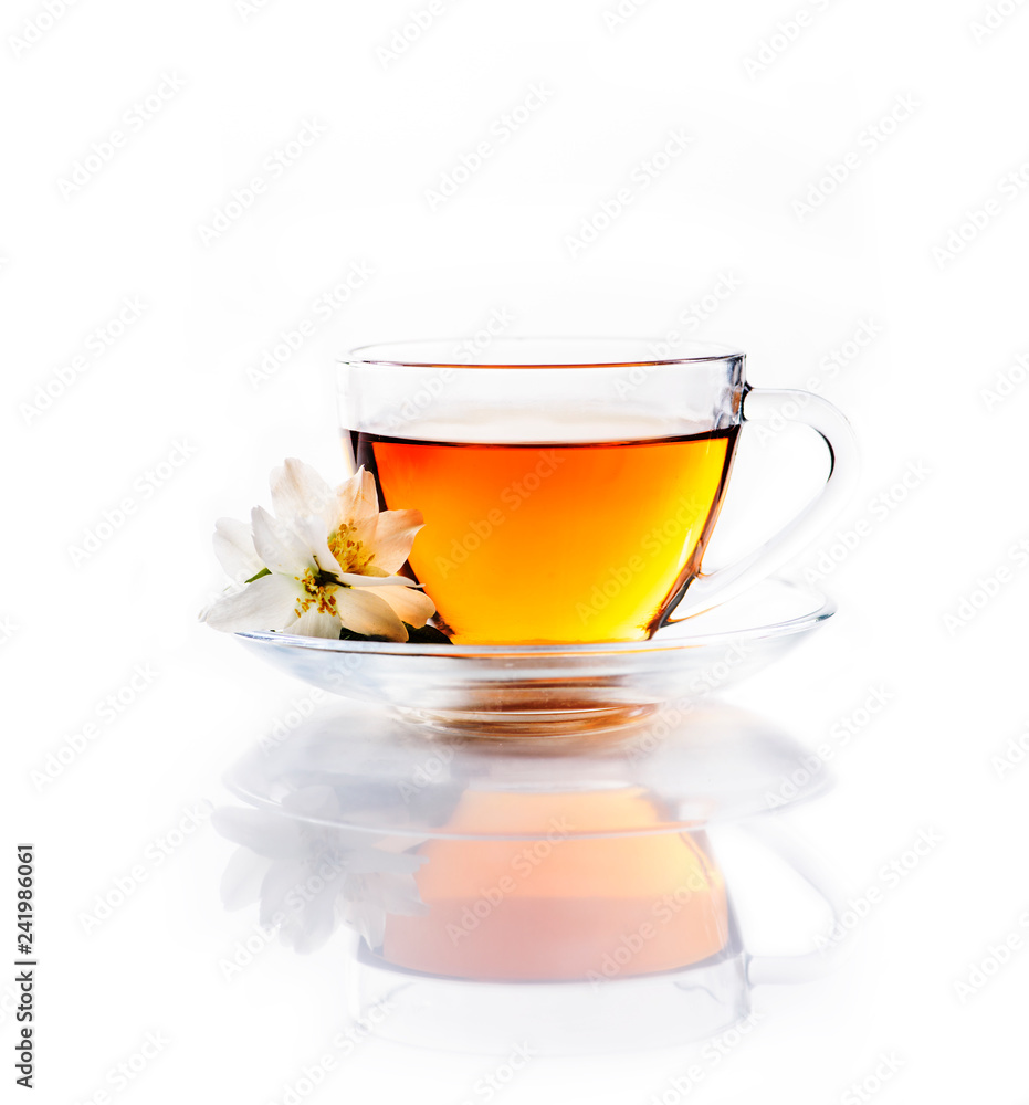Asian green tea with jasmine flower in transparent teacup isolated on white background with reflection. Asian green tea with jasmine flower in transparent teacup isolated on white background with reflection.