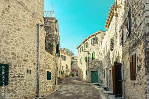 Narrow street of old town in Murter, Croatia photo