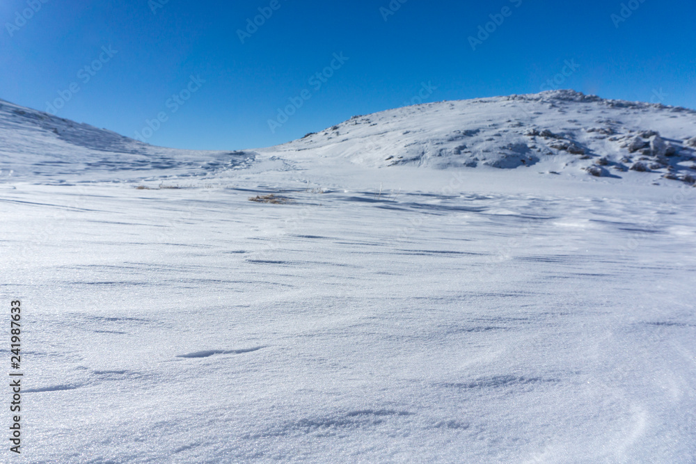 Winter landscape in a sunny day on the snow covered mountain 