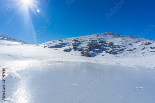 Winter landscape with a frozen lake on a sunny day near mountain Velouchi in Evritania  Greece 