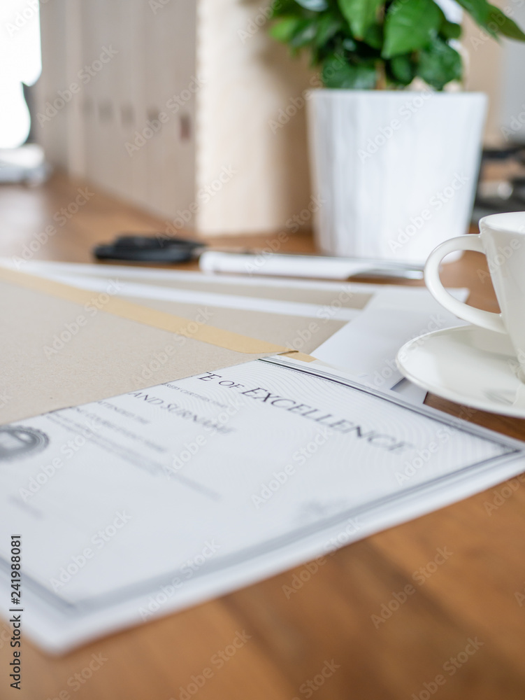 A certificate in a hard paper envelope placed on the desk in office. 