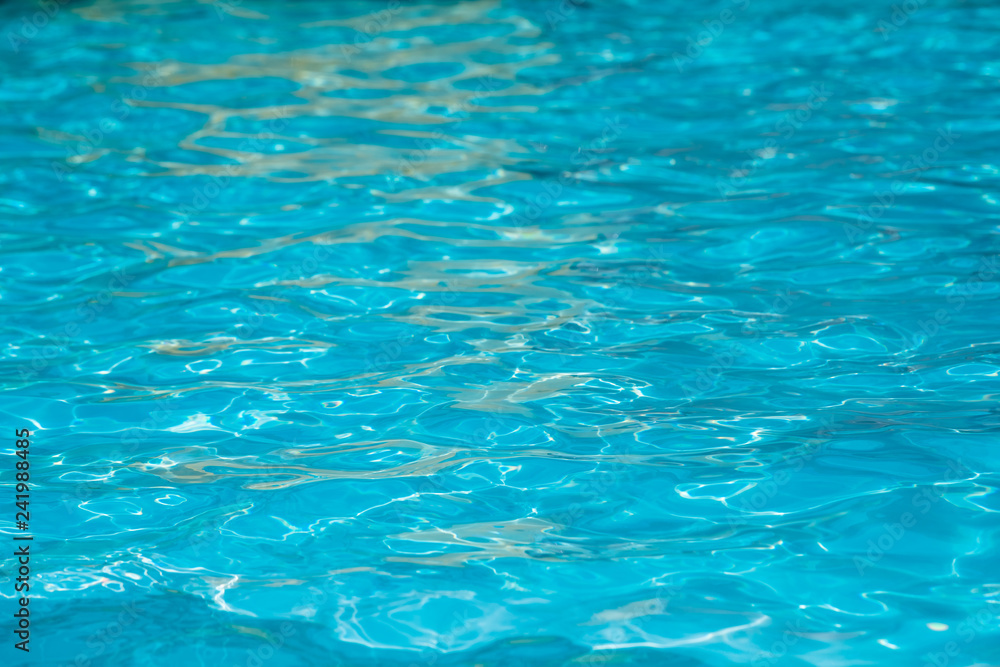 Blue and bright water in swimming pool with sun reflection, Motion of ripple water and gentle wave in pool