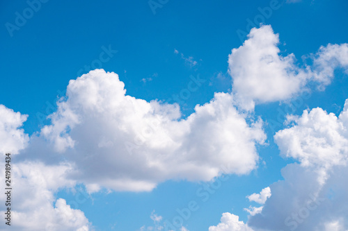 The blue sky with moving white clouds. The sky is a beautiful color shade suitable for use as a background image.