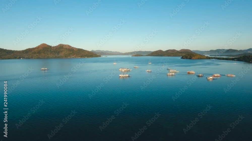 aerial tropical bay with boats, mountains on the island. Seascape beautiful tropical cove. Scenic landscape with mountain islands and blue lagoon Philippines,Palawan, Busuanga Travel concept, Aerial aerial tropical bay with boats, mountains on the island. Seascape beautiful tropical cove. Scenic landscape with mountain islands and blue lagoon Philippines,Palawan, Busuanga Travel concept, Aerial