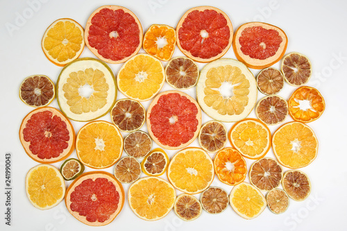 mix of different pieces of dried citrus fruit on white background