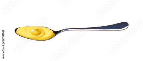 Yellow sauce in small metal spoon isolated on white background,