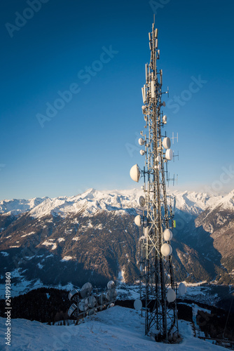 Tv/ Radio Antenna in the Italian Alps infront of snowy mountains