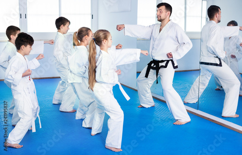 Children trying martial moves in karate class