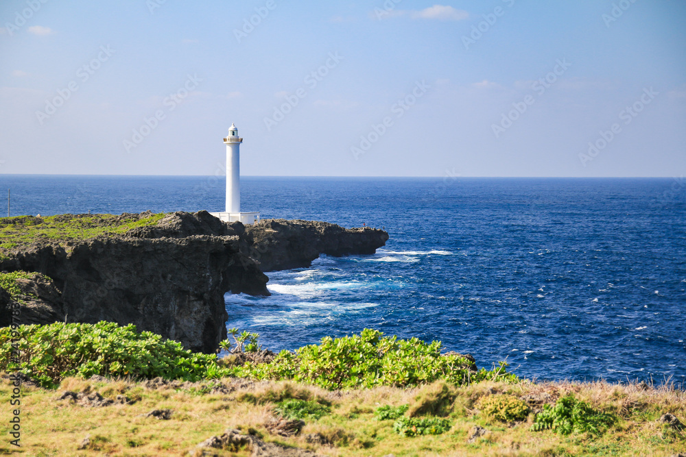 white lighthouse in cape zanpa with blue sea and sky
