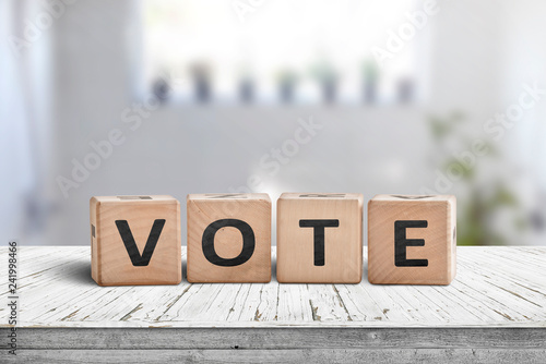 Vote sign made of wood in a bright room