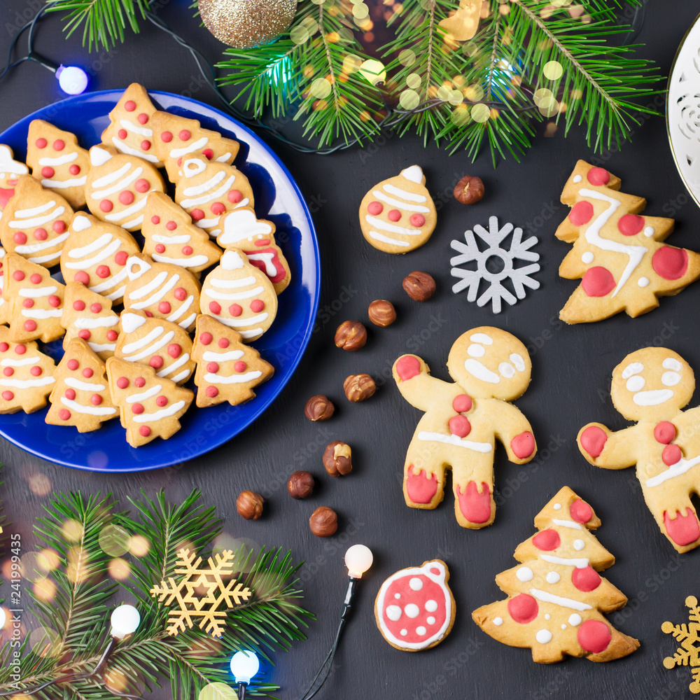 Tasty Christmas cookies, Christmas tree, decorations on black background. Christmas cooking concept Tasty Christmas cookies, Christmas tree, decorations on black background. Christmas cooking concept