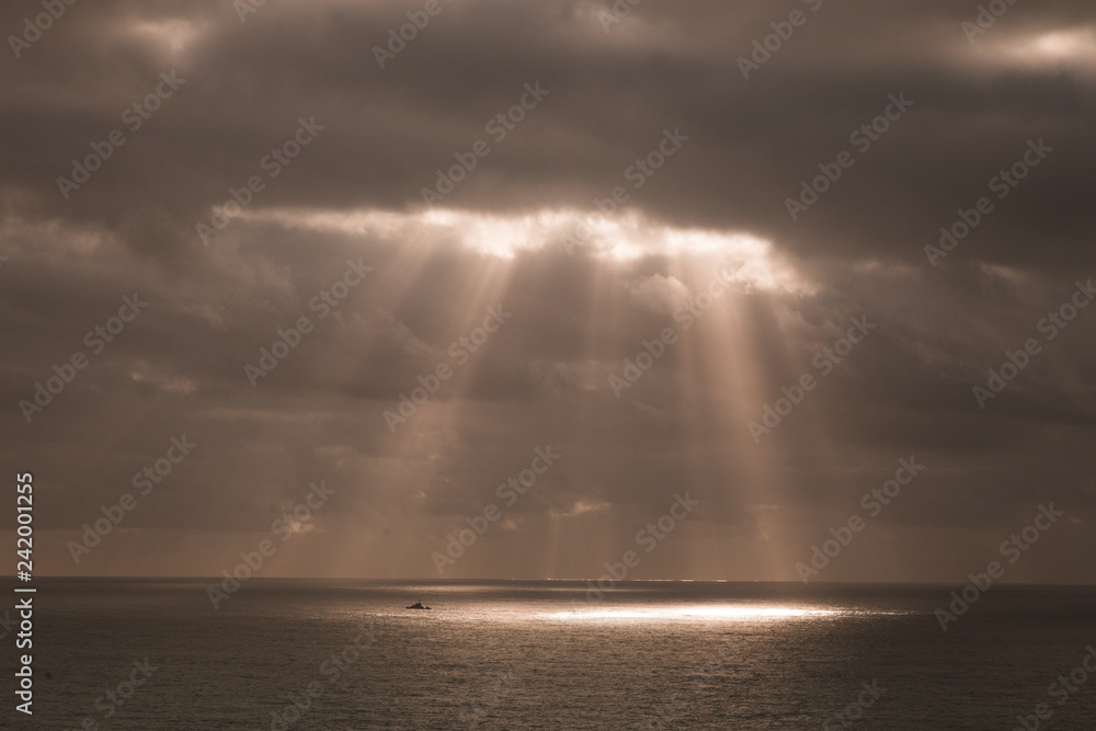 Rays of light on  the sea sepia
