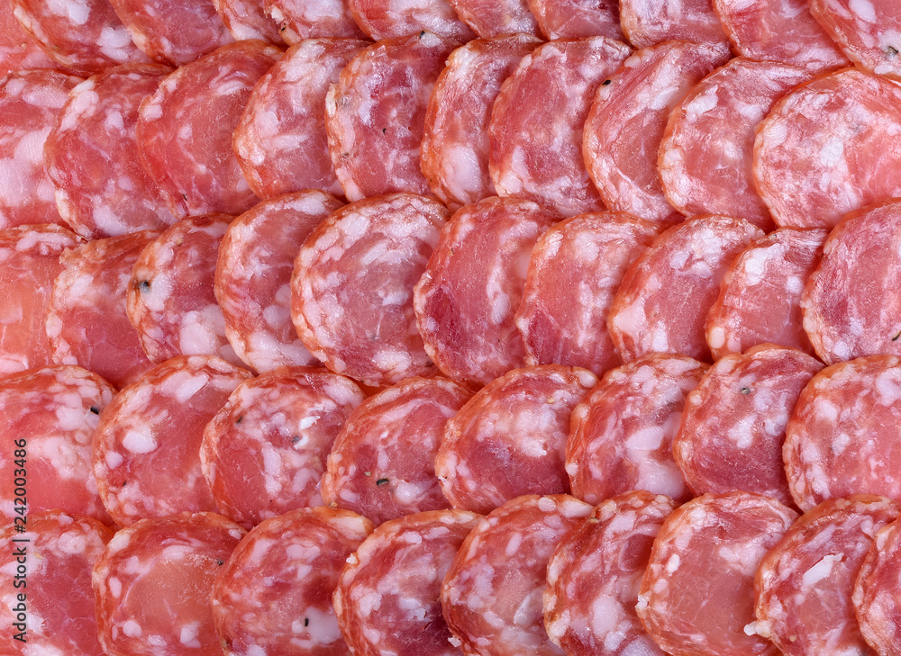 Salami sausage slices background. Close up. Slices of smoked sausage. Food background. Salami sausage slices background. Close up. Slices of smoked sausage. Food background.