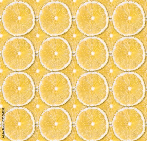 Background of fresh yellow lemon slices. Seamless pattern. Close up. Studio photography.