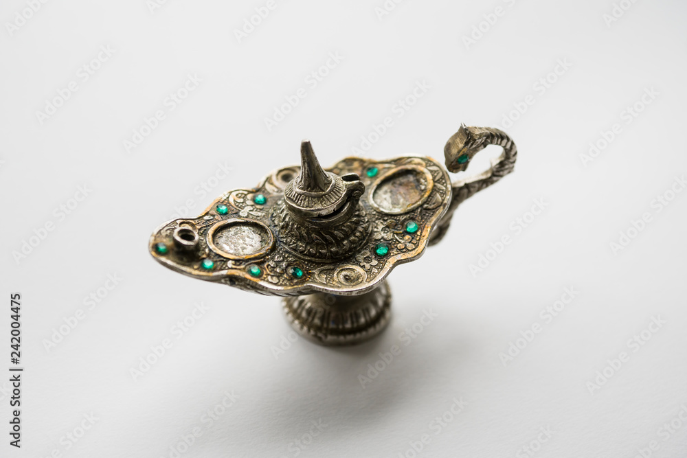 A vessel for incense made of metal with green stones. The image on a white background. Copy space. A vessel for incense made of metal with green stones. The image on a white background. Copy space.