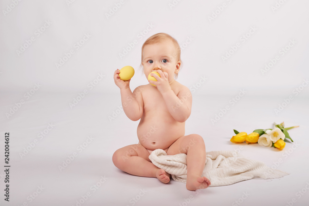 cute toddler boy on a light background with a bouquet of flowers cute toddler boy on a light background with a bouquet of flowers