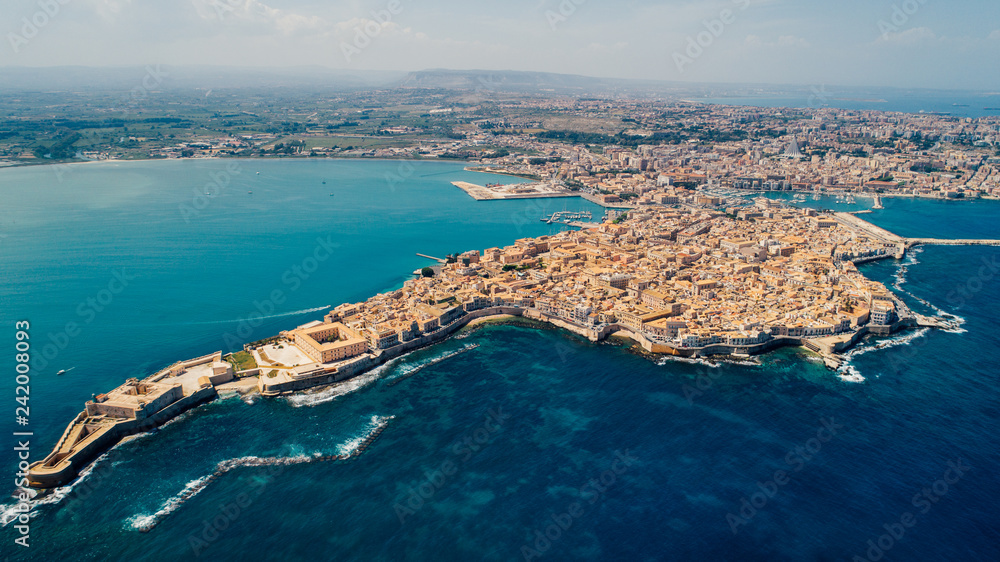 Aerial panoramic view of Ortigia island,old town of Syracuse.Small island on Sicily,Italy.Sicilian vacation,charming Italian experience.Beautiful seaside landscape